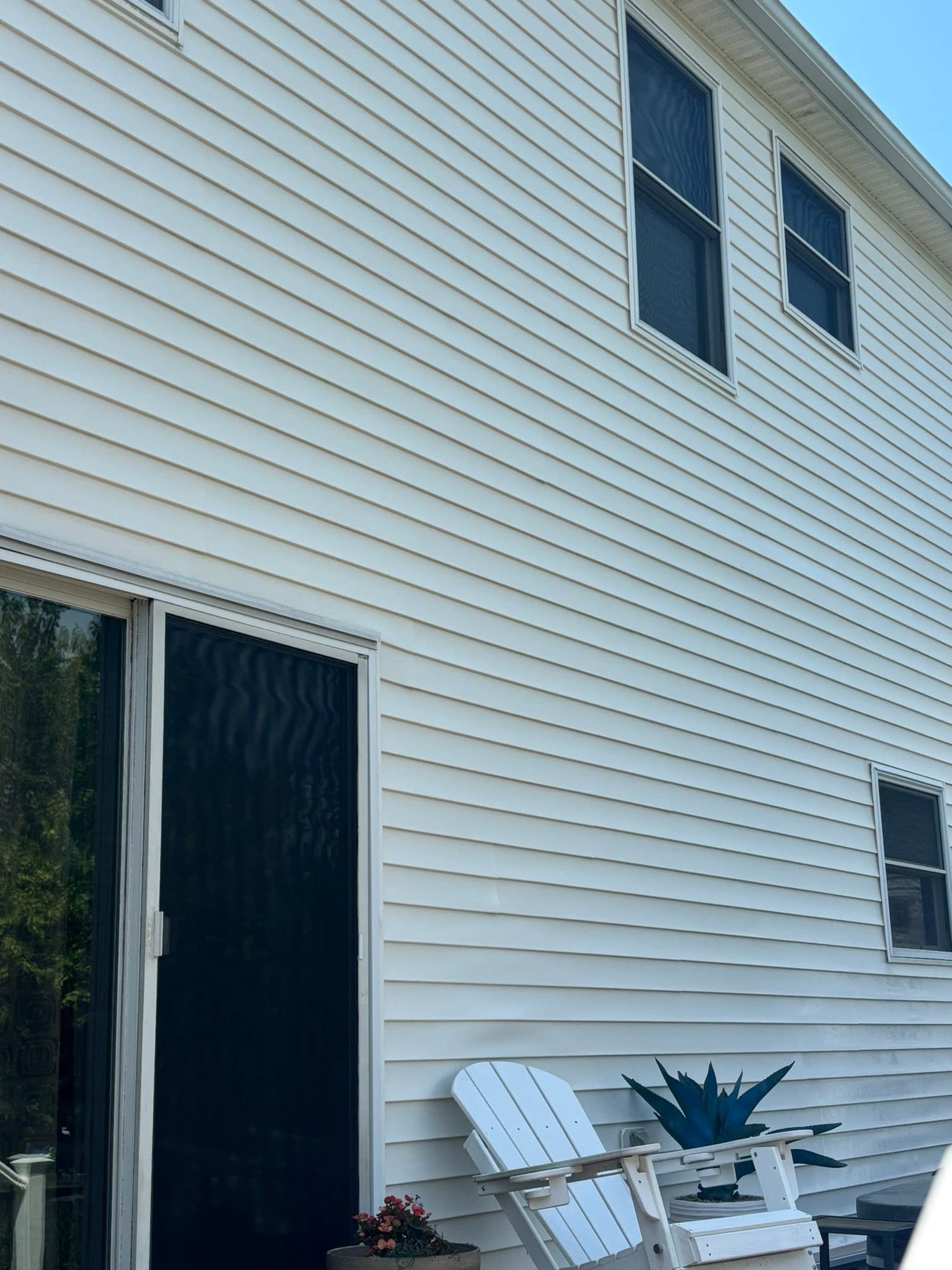 The same two-story house siding after exterior cleaning
