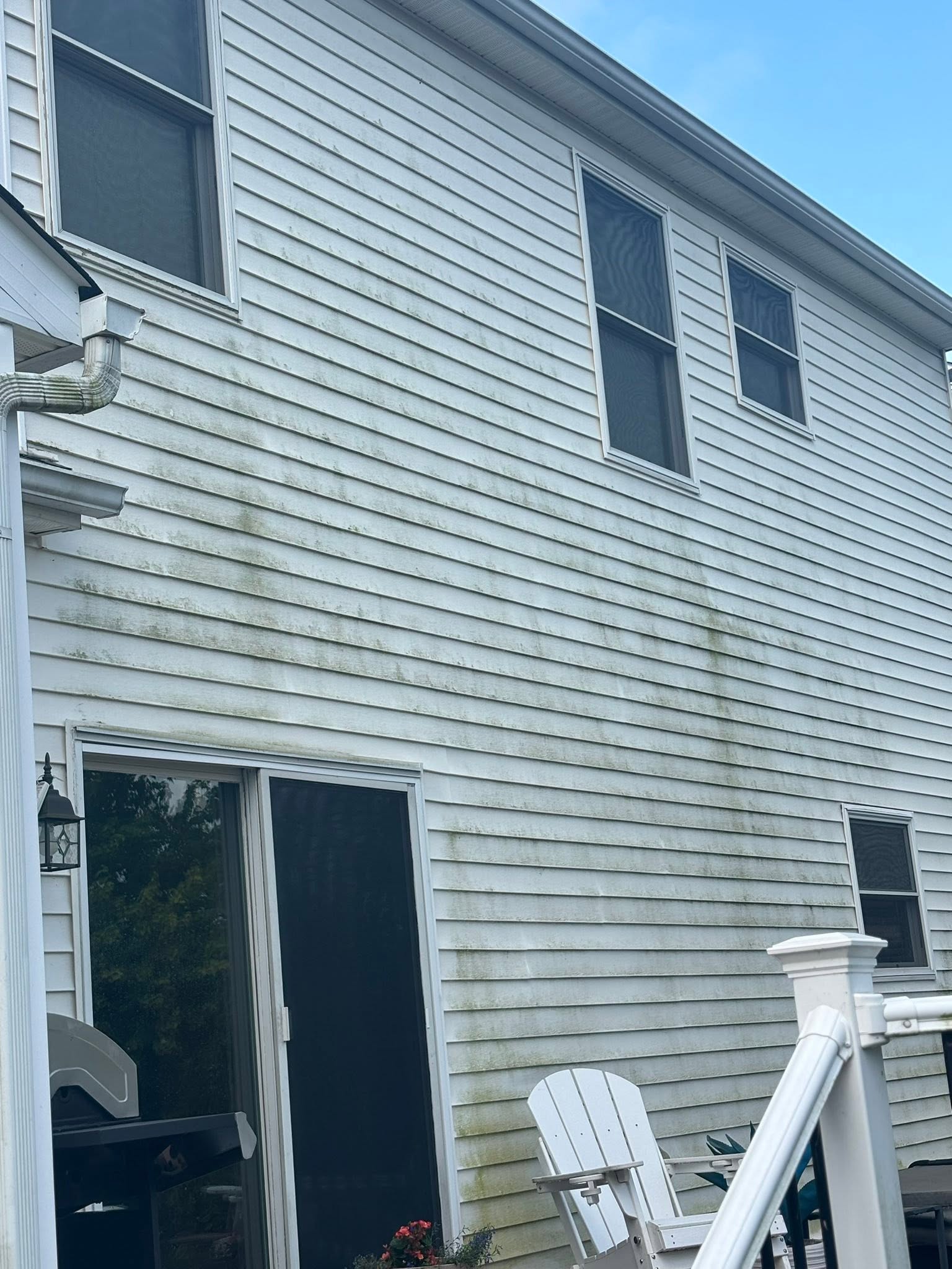 Two-story house siding before exterior cleaning