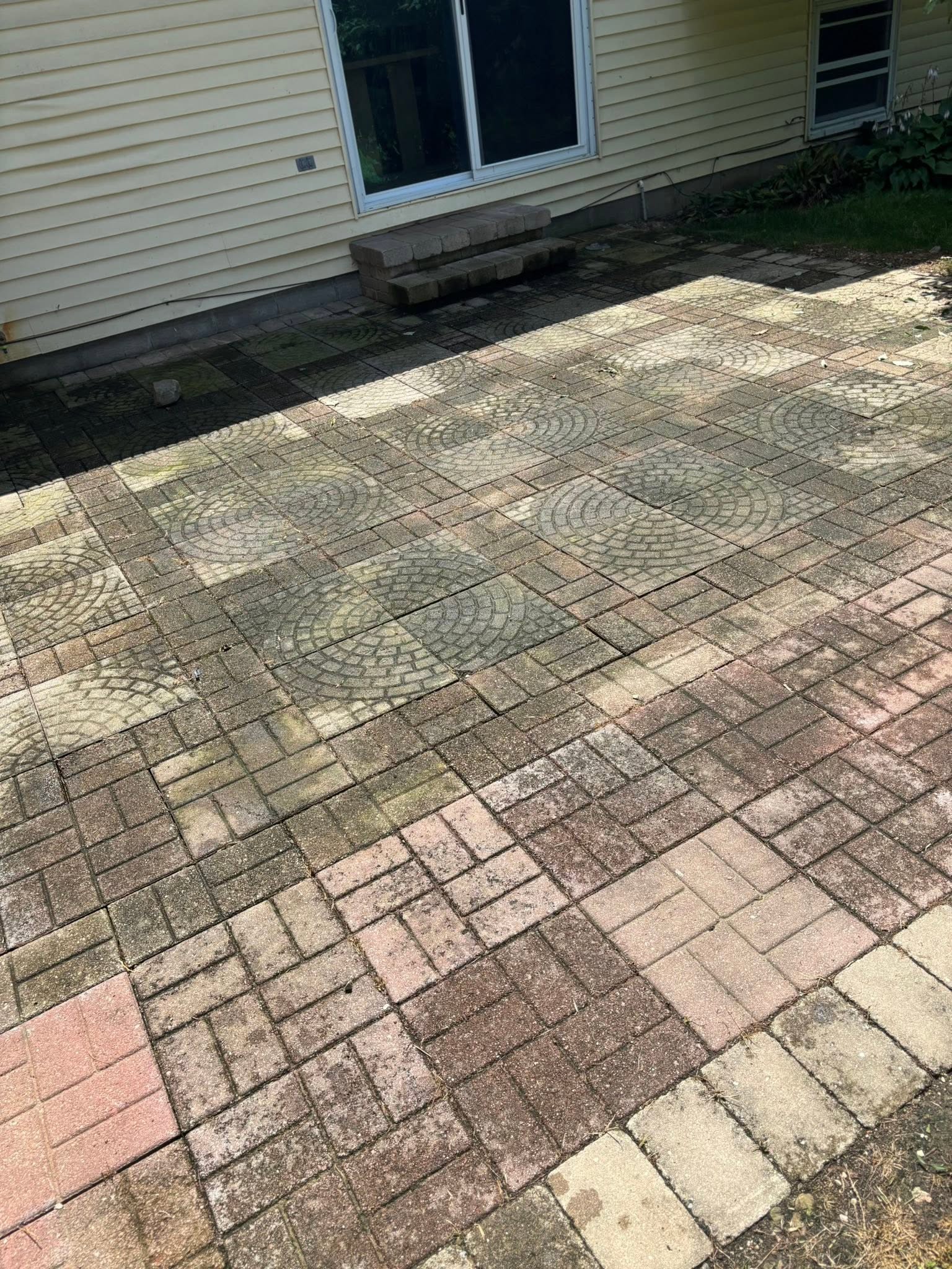 Patterned paver patio before cleaning